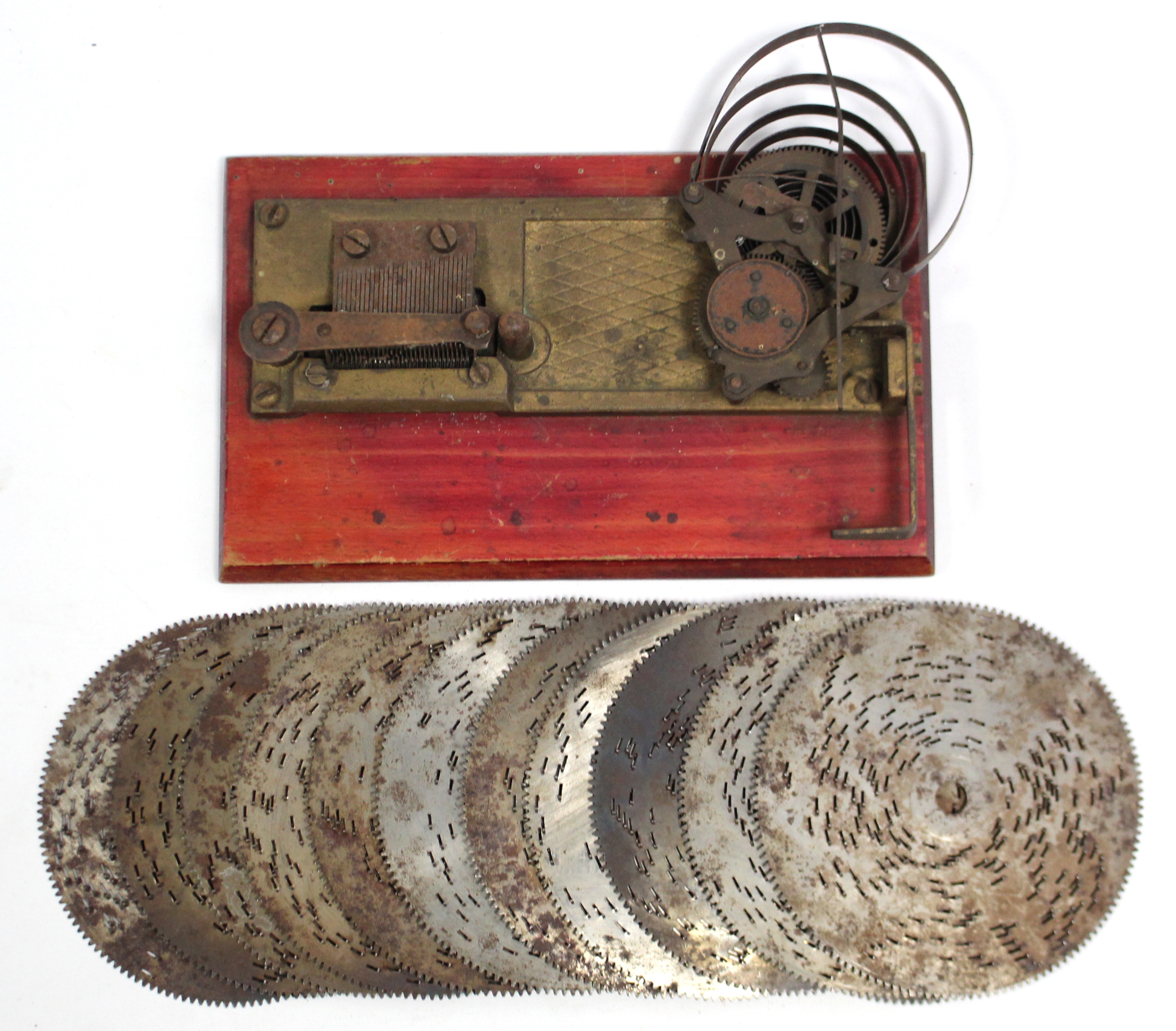 A Heluetia table-top music box (lacking case); & twelve ditto 4½” diam. discs.