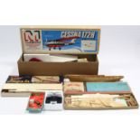 Three various model aeroplane kits; & a model ship kit, part incomplete.