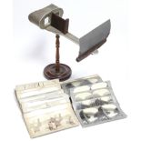 A late 19th century American patent stereoscope viewer on mahogany stand with turned centre column &