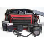 A Canon “T80” camera with various accessories.