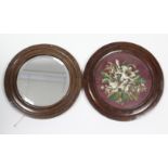 A 19th century oak circular picture frame inset floral needlework panel, 19½” diam.; & a similar