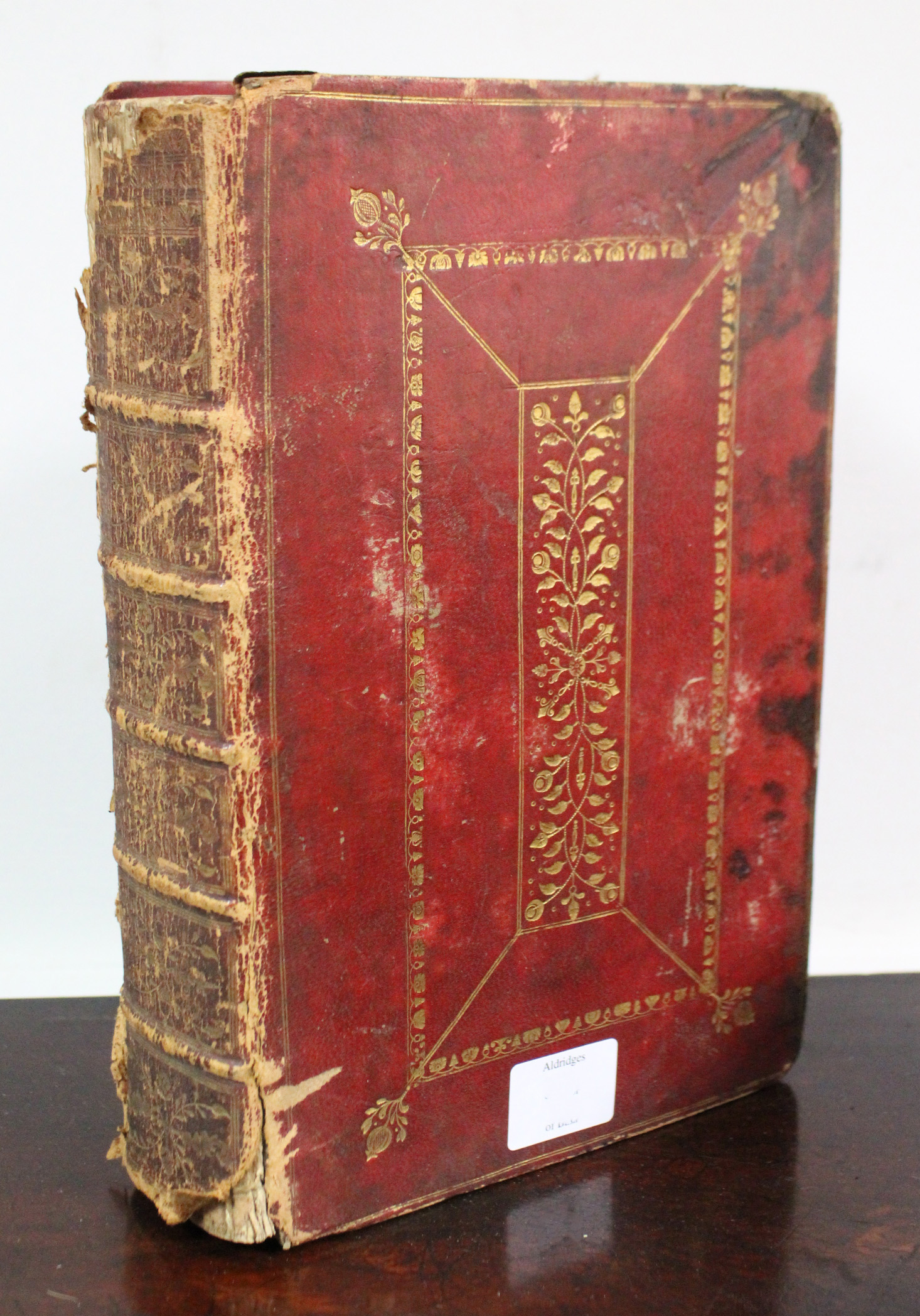 An 18th century Common Prayer Book in gilt-tooled crimson leather binding.