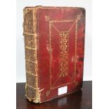 An 18th century Common Prayer Book in gilt-tooled crimson leather binding.