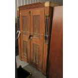 A continental-style grained pine wardrobe enclosed by pair of panel doors, with half turned