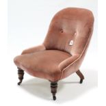 A late Victorian buttoned-back child’s chair upholstered rose-pink velour, & on short turned legs