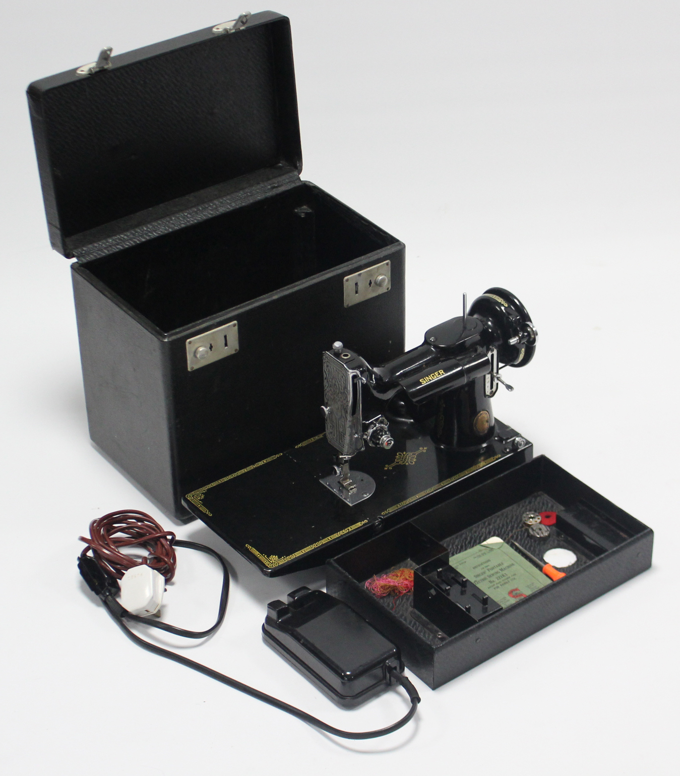 A vintage Singer portable electric sewing machine “model No. 221K1” with case.