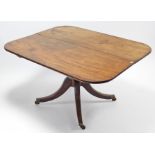 A regency mahogany pedestal breakfast table, with rounded corners to the rectangular top, & on