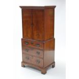 A reproduction 18th century style cabinet, fitted two shelves to the top enclosed by a pair of panel