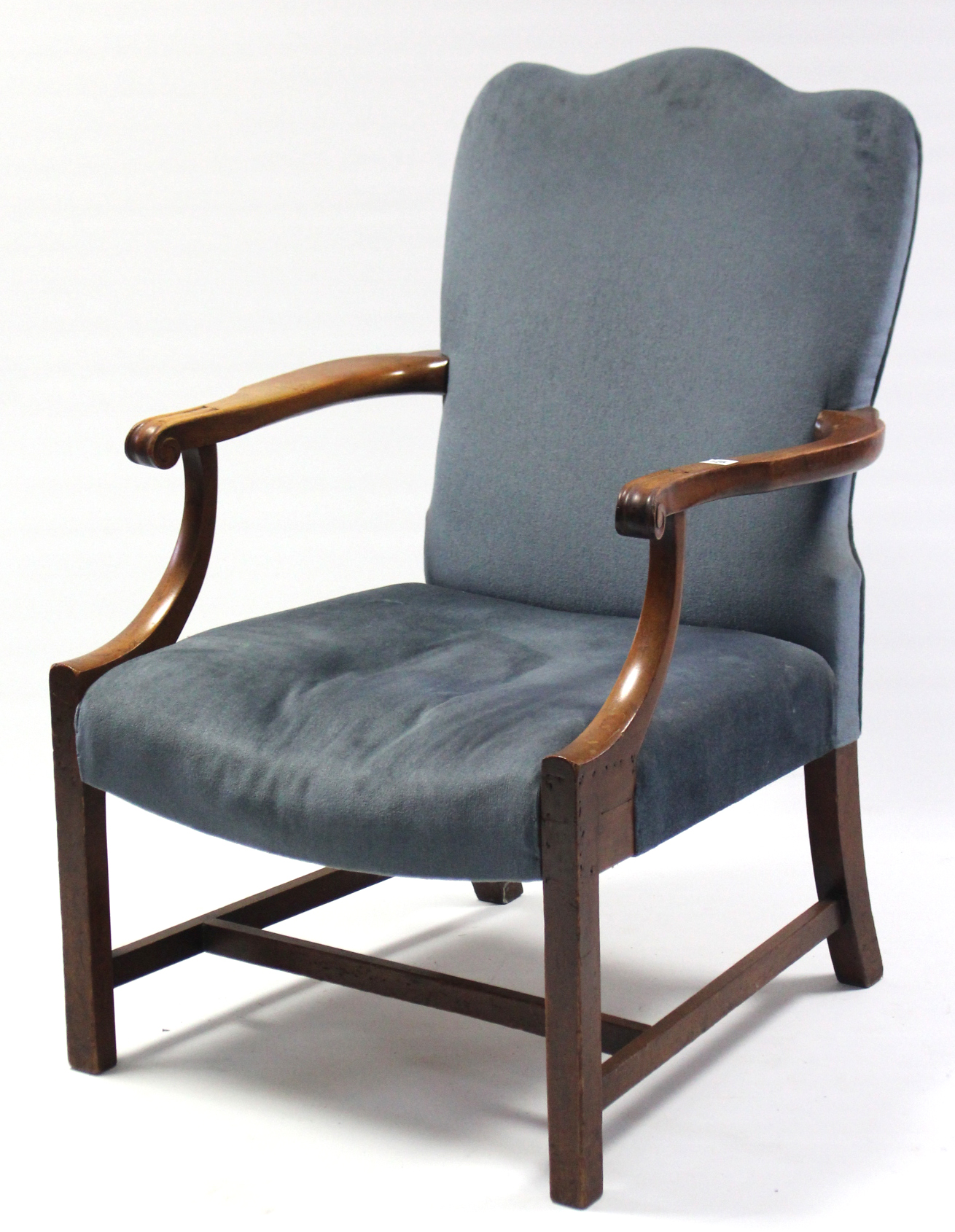 A Georgian-style armchair with padded back & sprung seat upholstered blue velour, & on chamfered