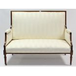 A late 19th century show-wood frame two-seater settee upholstered ivory striped material, & on