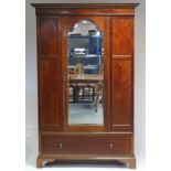 An Edwardian inlaid-mahogany wardrobe with moulded cornice, enclosed by rectangular bevelled