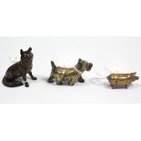 A novelty brass vesta case in the form of a pig, 2” long; a bronzed seated dog ornament, 2¼” high; &