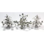 Three white painted wrought-metal foliate-design ceiling light fittings.