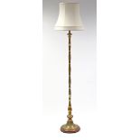 A brass standard lamp with bamboo-effect centre column, on circular pedestal base; 69” high. (