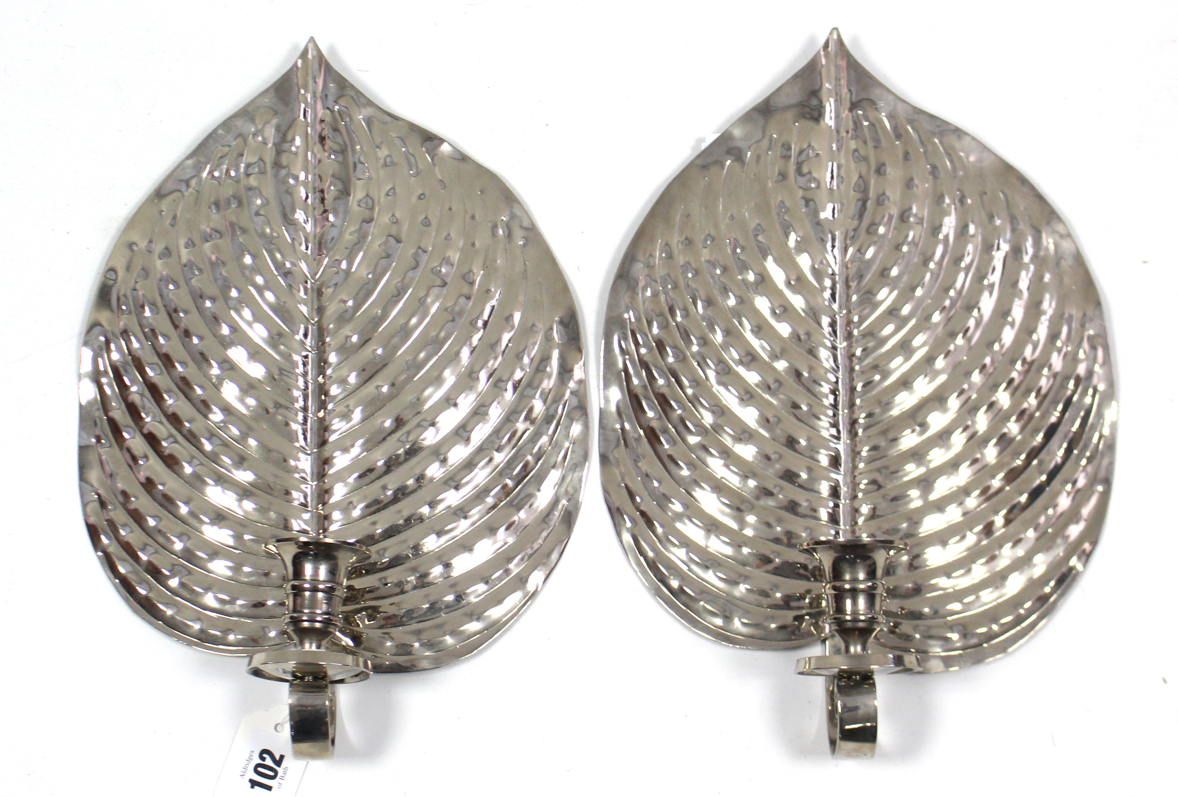 A pair of silvered-metal foliate design wall sconces, after a design by Jane Knapp, 12¾” x 8¾”.