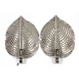 A pair of silvered-metal foliate design wall sconces, after a design by Jane Knapp, 12¾” x 8¾”.