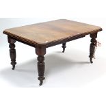 A Victorian walnut extending dining table with canted corners & moulded edge to the rectangular top,