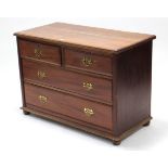 A late Victorian walnut dwarf chest, fitted two short & two long graduated drawers with brass