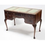 A mahogany writing table, inset gilt-tooled green leather cloth, fitted five drawers, & on slender