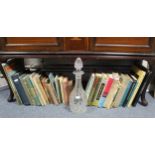 Various books & novels; & a cut-glass mallet-shaped decanter.