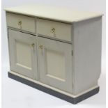 A cream painted pine low sideboard fitted two frieze drawers above cupboard enclosed by pair of