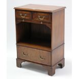 A reproduction walnut small side cabinet, fitted two frieze drawers above a brushing slide with open