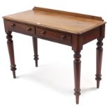 A Victorian mahogany side table fitted two frieze drawers, & on turned tapered legs, 40½” wide.