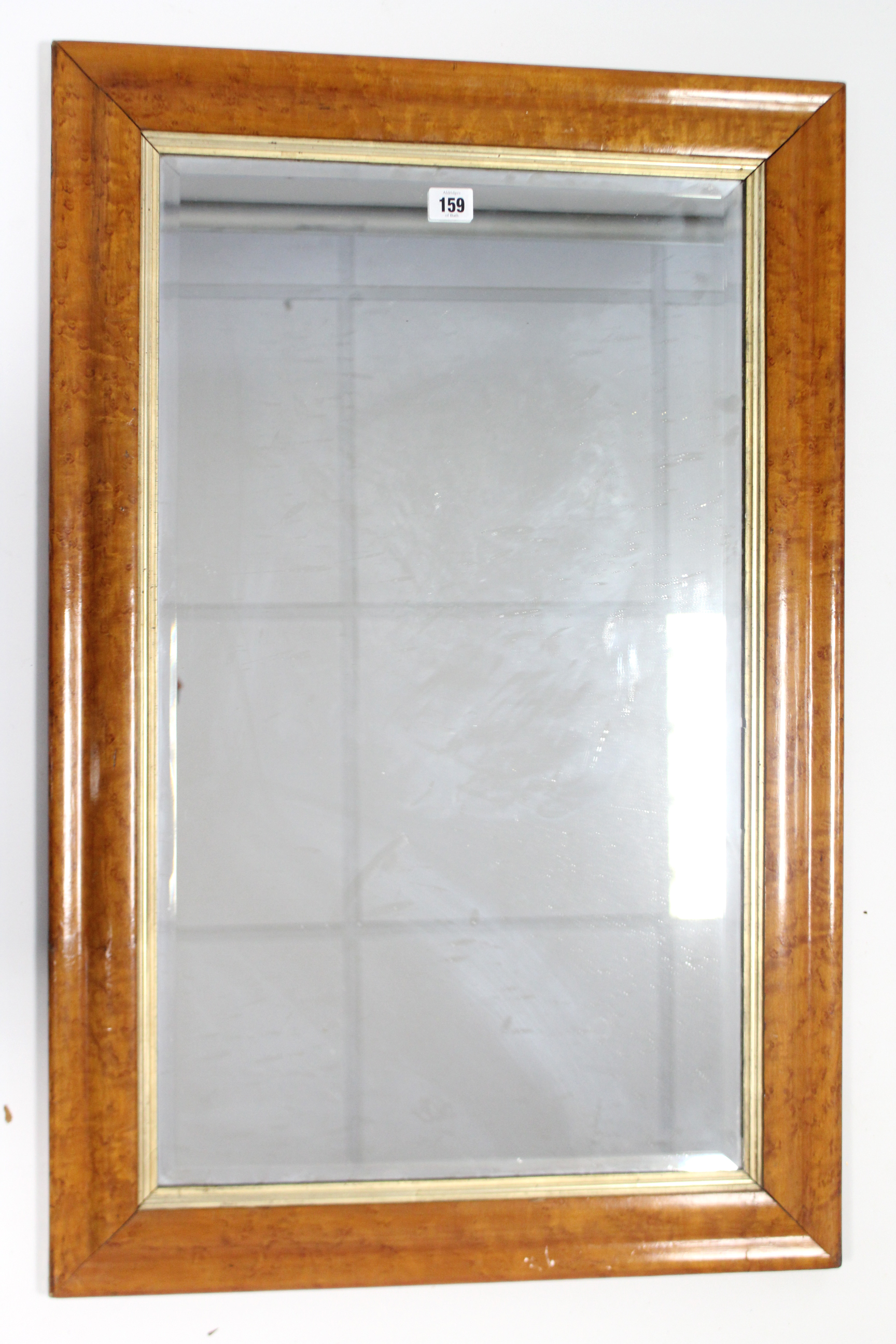 A rectangular wall mirror inset bevelled plate, & in bird’s-eye-maple frame, 34” x 22”.