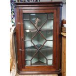 A 19th century oak hanging corner cabinet fitted two shelves enclosed by glazed door, 28½” x 40­”.