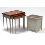 A reproduction painted nest of three rectangular occasional tables, 23” wide together with a similar