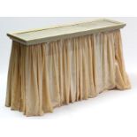 A silvered-finish frame rectangular console table with peach coloured drapes, 46” wide.