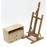 An artist’s portable easel; together with a plywood stationary rack; & a rug.
