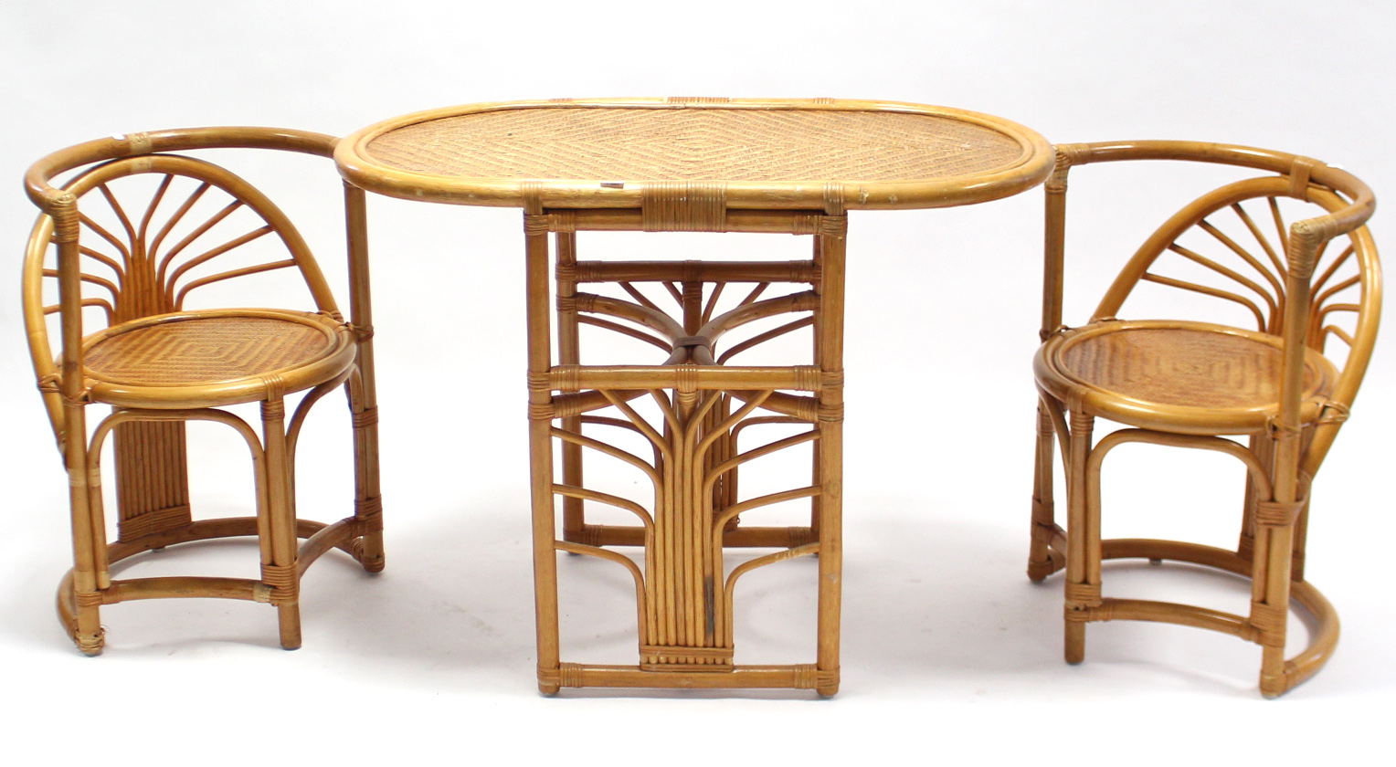 A cane kitchen table with rounded corners to the rectangular top, & on round supports; & a ditto