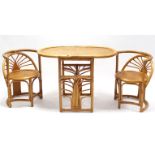 A cane kitchen table with rounded corners to the rectangular top, & on round supports; & a ditto