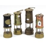 Four various Welsh miner’s lamps.