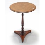 A 19th century mahogany tripod table with circular top, & on vase-turned centre column & triform