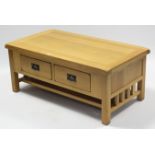 A ditto rectangular low coffee table, fitted two frieze drawers to one side, & on square legs with