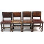 A set of four Cromwellian-style oak dining chairs with brass studded seats & backs, & on turned legs
