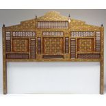 An eastern large hardwood headboard, with all-over inlaid decoration, architectural pediment, &