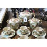 A Japanese Satsuma pottery twenty seven piece coffee service (settings for twelve), with bright-