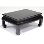 A similar Chinese black-lacquered rectangular coffee table, on carved square legs with block feet;