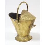 An early 20th century brass embossed helmet shaped coal scuttle, 14” high & various other items of