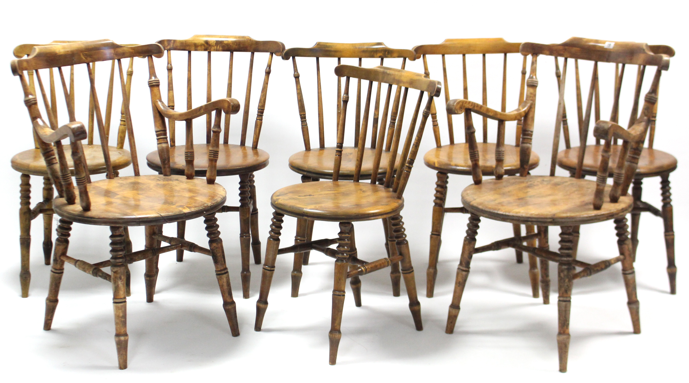 A set of eight spindle-back dining chairs (including a pair of carvers) with hard circular