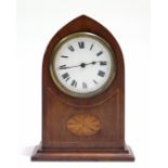 An Edwardian mantel timepiece with black roman numerals to the white enamel dial, & in inlaid-