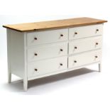An Ikea pine & white-finish low chest fitted two ranks of three long drawers (lacking backboard),