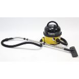 A Numatic “Henry” cylinder vacuum cleaner.