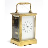 A brass-cased carriage clock, 5” high.