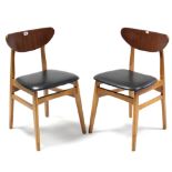 A pair of mahogany-finish bow-back dining chairs with padded seats, & on square tapered legs with