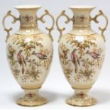 A pair of Crown Ducal ware ovoid two-handled vases of buff ground & with bright-coloured exotic bird