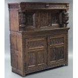A 17th century CARVED OAK COURT CUPBOARD, with all-over stylised floral decoration, the upper part